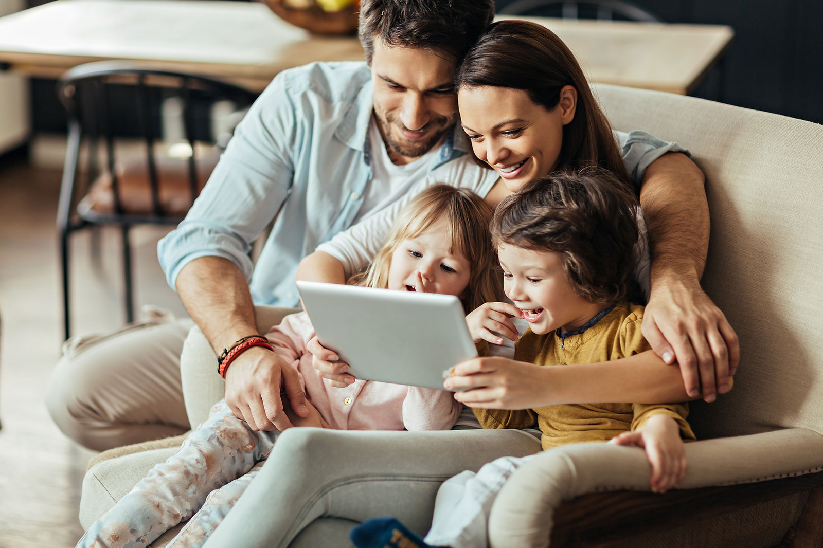 Family using a tablet together at home